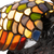 Detail Tiffany reigerlamp van glas in lood in groen-, amber-, crème- en blauwtinten