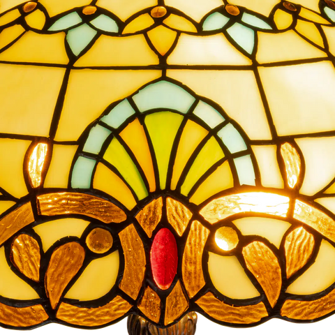 Detail Tiffany vloerlamp art nouveau met sierpatroon van glas in lood in geel-, groen- en ambertinten