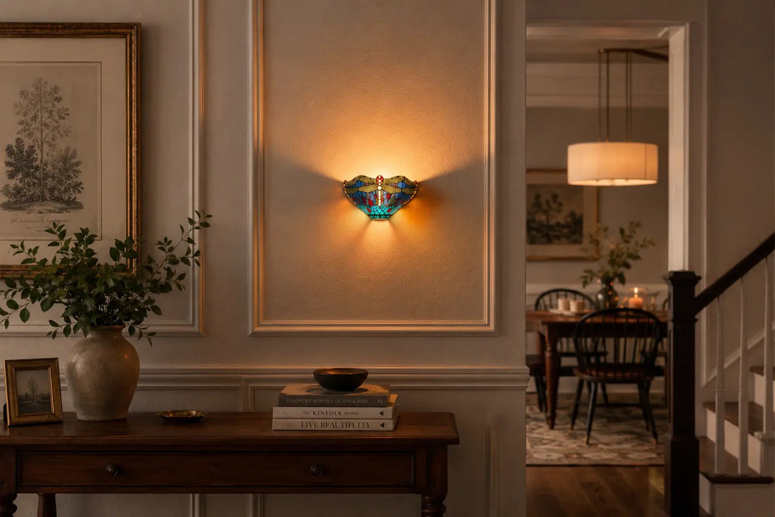 Tiffany wandlamp met libellemotief aan een klassieke paneelwand naast een leren Chesterfield-bank en stijlvolle leeshoek | RORUVERA