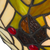Detail Tiffany wandlamp herfst en bladeren van glas in lood in groen-, bruin- en crèmetinten