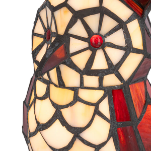 Detail Tiffany uillamp met bronskleurige voet in boomstronkvorm van glas in lood in rood,- en cremetinten