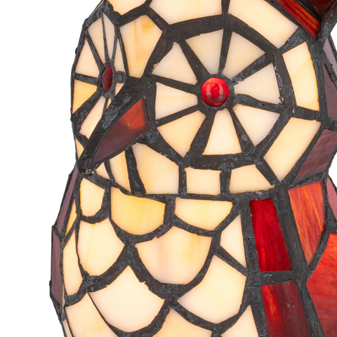 Detail Tiffany uillamp met bronskleurige voet in boomstronkvorm van glas in lood in rood,- en cremetinten