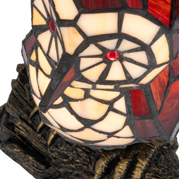 Detail Tiffany uillamp met bronskleurige voet in boomstronkvorm van glas in lood in rood,- en cremetinten