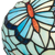 Detail Tiffany wandlamp vlinder van glas in lood in donker,- en lichtblauwtinten